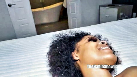 Chanel Star smiling in ecstasy on bed, curly-haired ebony beauty