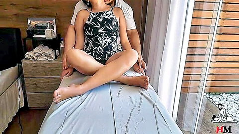 Therapist touches fit Latina in black swimsuit during tantric massage session