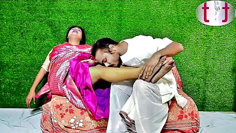 Indian newlywed couple in saree intimate foot kiss moment