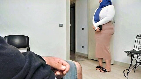 Shocked hijab wife in tight skirt standing with seated man