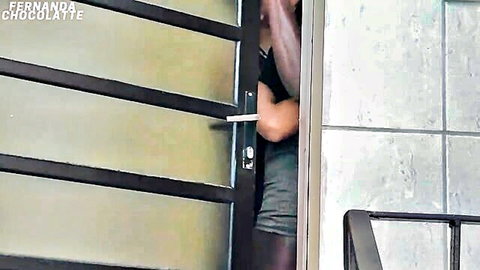 Japa Loki peeking from barred door in gray dress and black stockings, teasing anal ride
