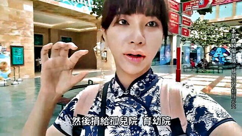 Asian woman in blue cheongsam posing playfully outdoors in Singapore
