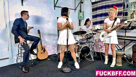 Korean teen BFFs in cheerleader outfits performing band show with manager