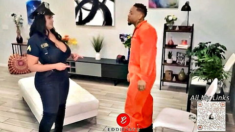 Curvy police officer in uniform with huge cleavage stands with convict in orange jumpsuit