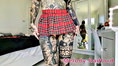 Melody Radford in short red plaid skirt try-on, tattooed thighs closeup