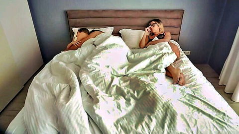 Blonde MILF Kelly Aleman in bed with partner, seductive threesome tease