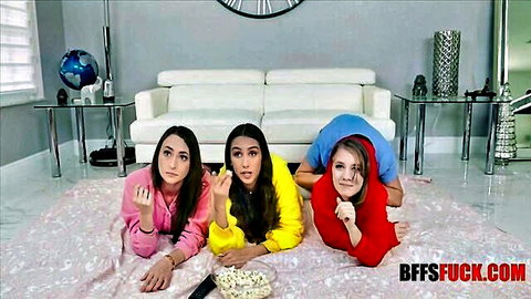Three teen besties in hoodies lounge with popcorn for stepbrother movie night fun
