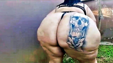 Mary Jhuana's huge tattooed ass in black thong, bending over outdoors