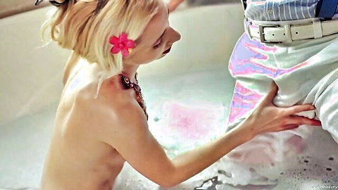 Blonde woman nude in bathtub touching man's crotch