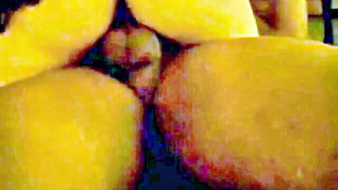 Close-up of yellow mangos arranged like intimate female anatomy