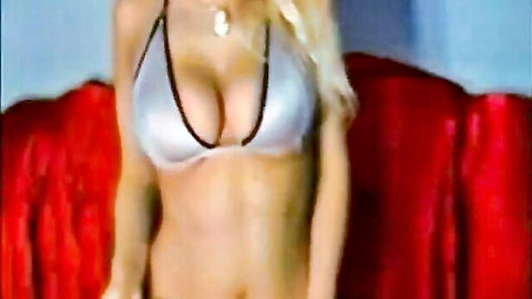 Blonde babe squeezing her big tits in revealing top, solo tease