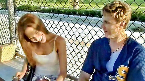 Anna De Ville in white tank top flirting with guy in baseball jersey on bench
