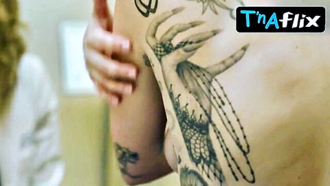 Lady Gaga topless showing intricate back tattoos in sexy scene
