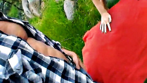 Outdoor couple sex in woods, man in open plaid shirt with busty woman in red dress