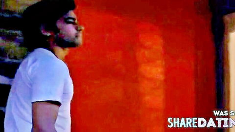 Handsome South Asian man in white tee seductive profile gaze eyes closed erotic tease