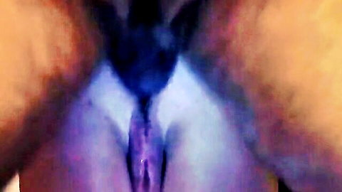 Close-up of spread wet pussy with black dildo inserted deep inside