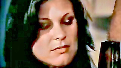 Seductive brunette with intense gaze in close-up classic adult scene