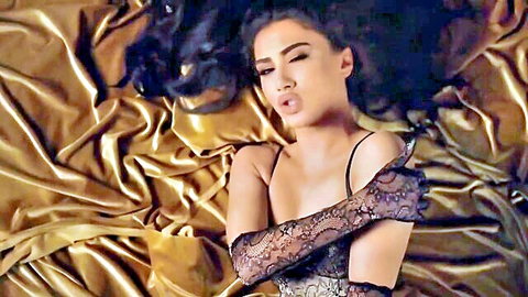 Melinda Ademi in black lace lingerie and gloves, seductive pout on bed