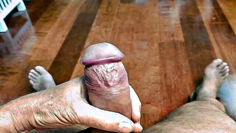 Mature nudist man holding erect penis, ready for cumshot