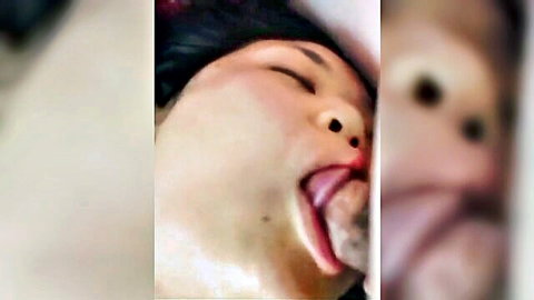 Korean beauty sticks out long tongue licking swollen cock head in closeup blowjob