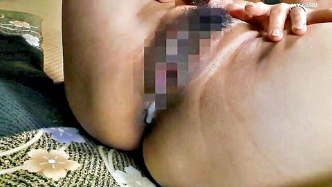 Mature Japanese MILF's thick ass cheeks spread wide with censored pussy exposed on bed