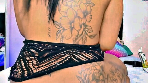 Tattooed ebony babe's massive bare ass cheeks exposed with black lace thong pulled down