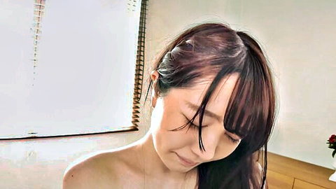 Ecstatic Japanese brunette with small tits bares shoulders in pleasure closeup
