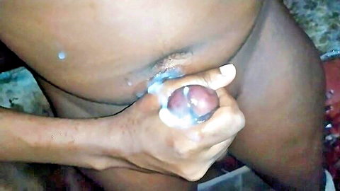 Black man grips thick uncut BBC with cum dripping onto hairy ebony pussy closeup