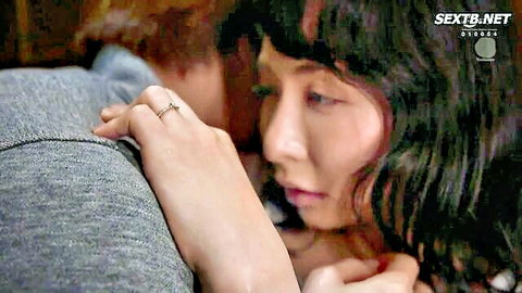 Intense close-up of Japanese MILF grabbed by lover's hand on neck during steamy embrace