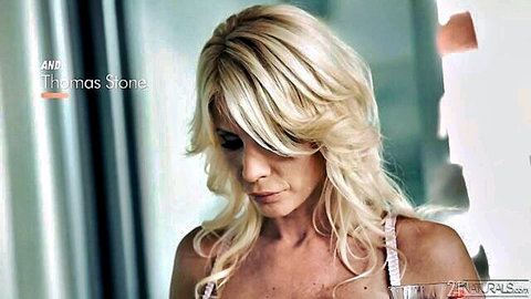 Blonde MILF in white lingerie looking seductive in closeup profile view