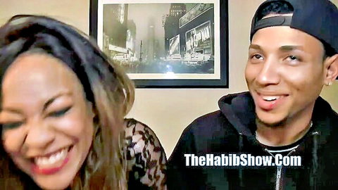 Ebony Lassie in lace top smiling on The Habib Show with host