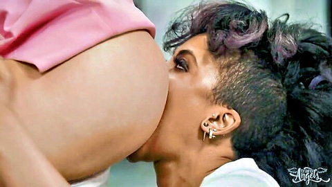 Edgy mohawk brunette sucking pregnant babe's exposed nipple with huge belly bulging
