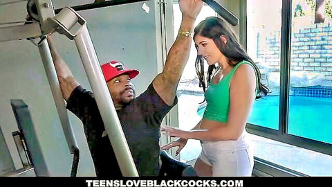 Fit teen in green tank top teases muscular black guy outdoors