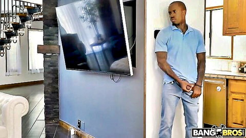 Muscular black stud in blue polo stands casually in kitchen ready for BBC action Bang Bros