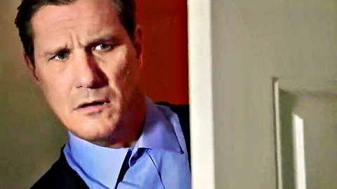 Surprised man in blue shirt and suit peeking through half-open door