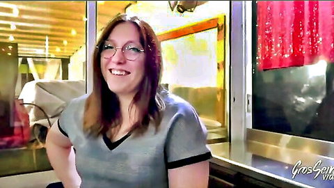 Lily smiling with glasses, brown hair, in gray top for monster cock debut