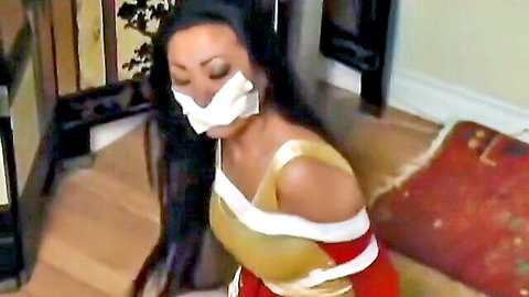 Asian superheroine bound and gagged in BDSM distress scene