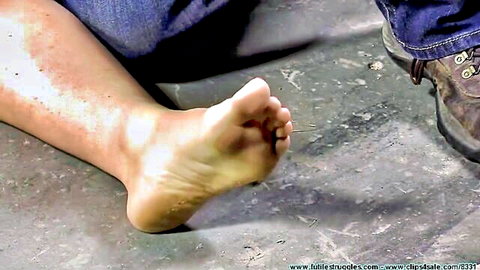 Adara's bare foot sole exposed in BDSM domination scene