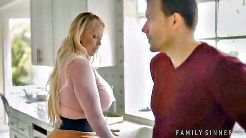 Blonde MILF with huge tits in tight pink top bends over kitchen sink as man stares from behind