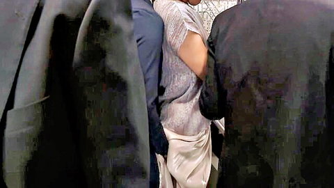 Sexy MILF in shimmering sequin gown squeezed between suited men at formal event