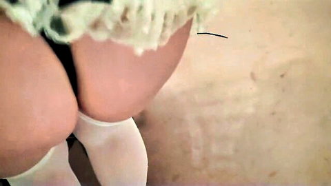 Mature maid in frilly outfit showing curvy ass and thighs in white stockings