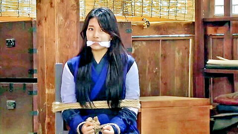 Japanese woman bound in ropes with white ball gag in mouth wearing blue kimono BDSM bondage