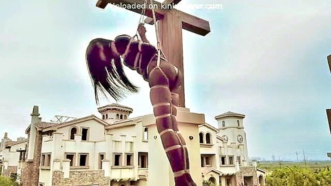 Upside-down Asian brunette suspended naked in outdoor shibari bondage exposing tits and pussy