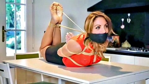 Alba bound and gagged in orange top and black skirt, BDSM bondage scene