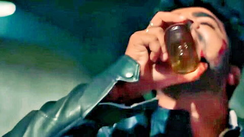 Intense BDSM man in leather jacket drinks with blood on face