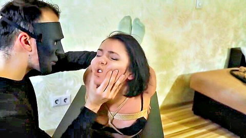 Yuno in BDSM bastinado teaser: masked man grips submissive Asian woman's face