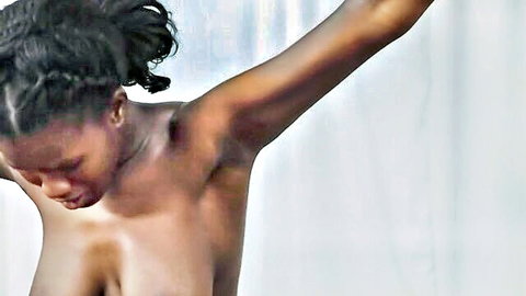 Alison Woodward topless ebony model with arms raised in seductive pose