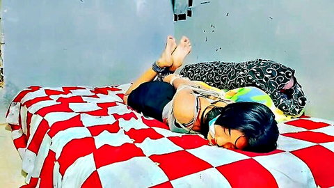 Bound Indonesian woman in BDSM bondage, blindfolded and restrained on bed