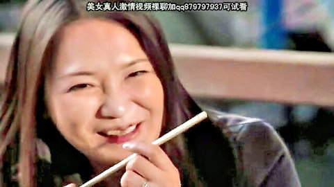 Smiling mature Japanese woman with chopsticks in JAV BDSM scene