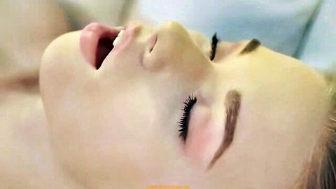 Blonde woman in ecstasy with eyes closed and mouth open